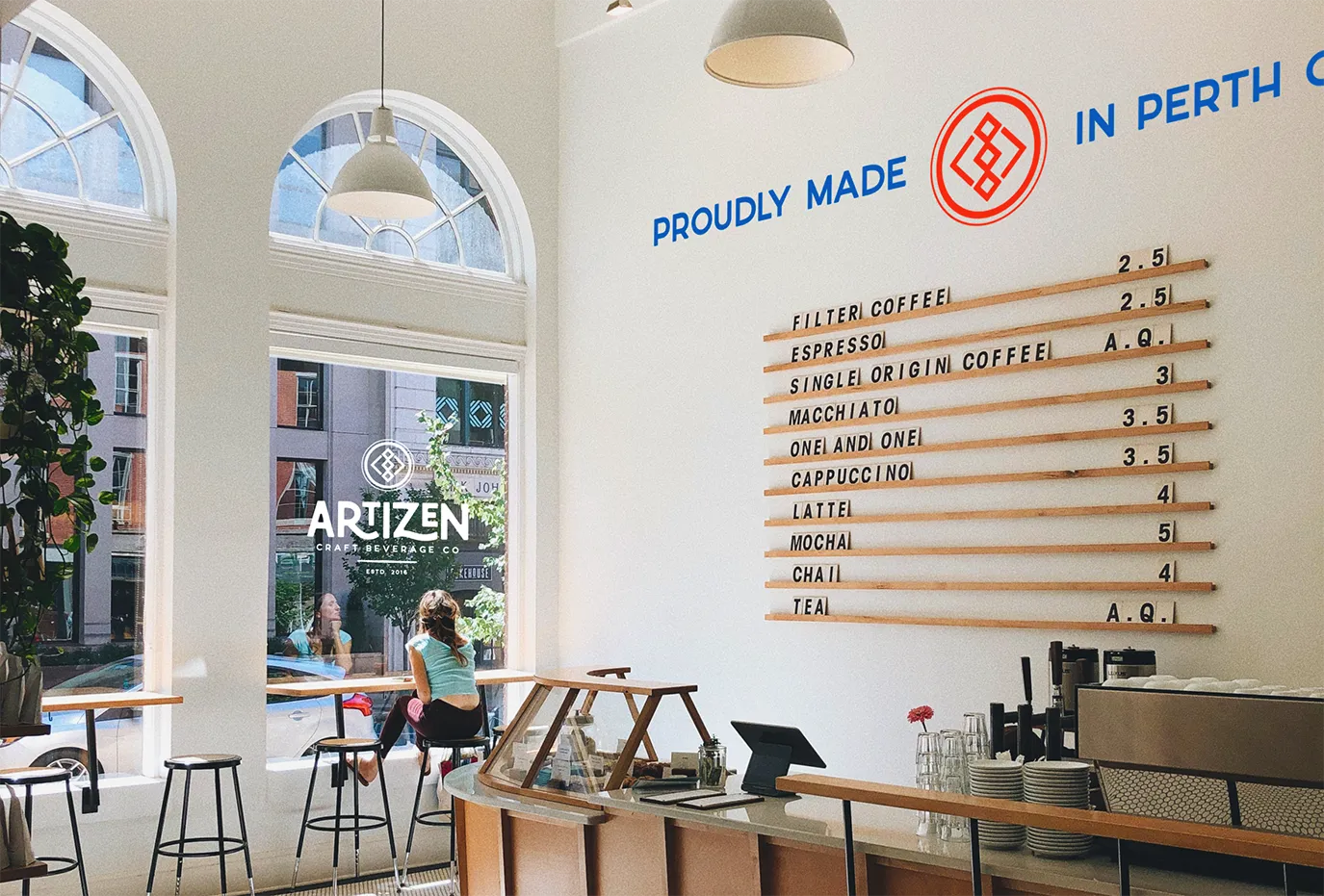 Artizen Craft Beverage Co. café branding featuring storefront logo and interior signage.