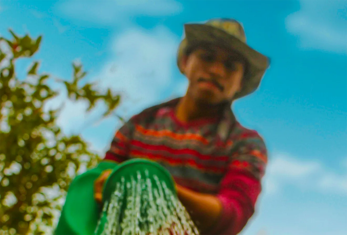 Artizen Craft Beverage Co. lifestyle photography featuring a local farmer watering crops.