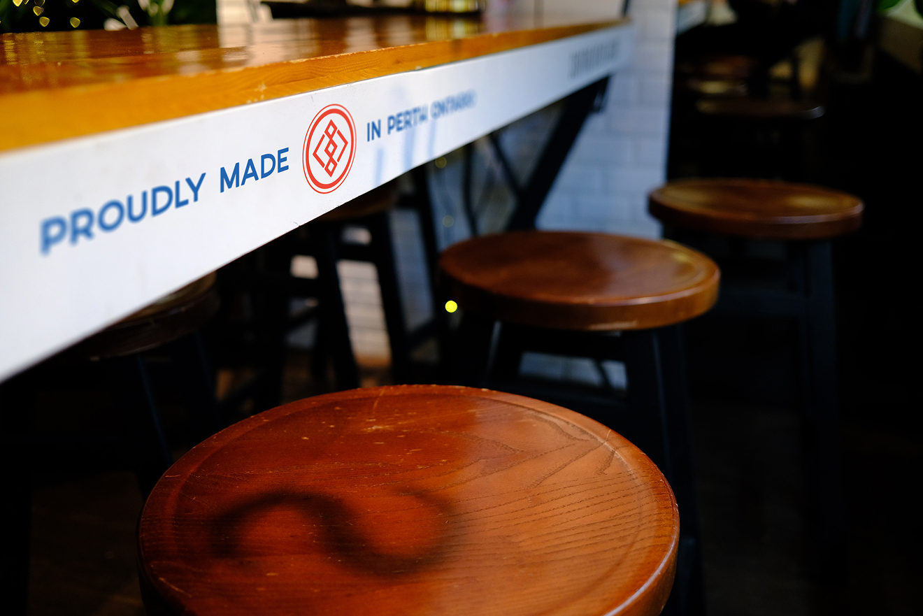 Artizen Craft Beverage Co. interior branding featuring bar signage and geometric logo.