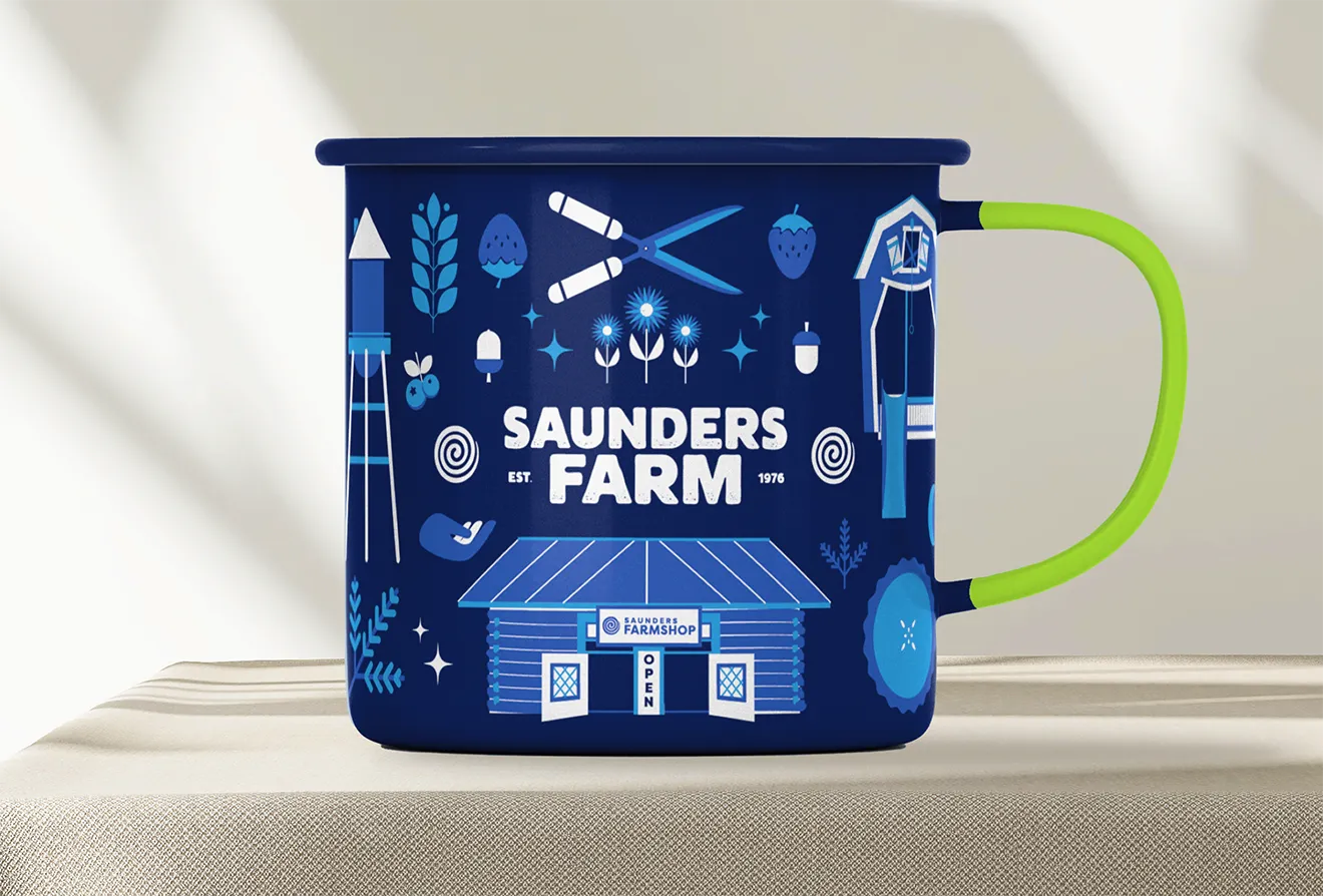 Saunders FarmShop ceramic mug featuring custom illustrated farm landscape pattern.