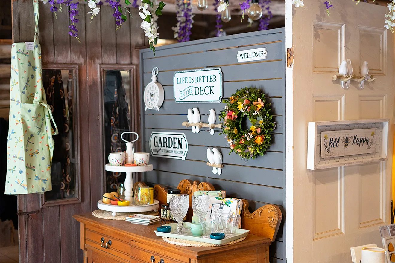 Saunders FarmShop retail store interior featuring rustic wood displays, seasonal merchandise, and farm-inspired decor.