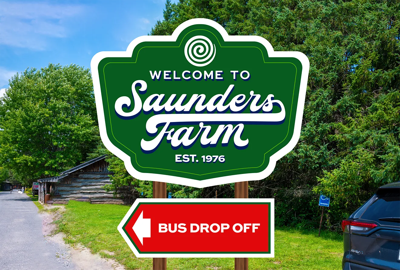 Saunders Farm main entrance sign reading 'Welcome to Saunders Farm Est. 1976' with a red 'Bus Drop Off' arrow sign below, designed by Hovski Studio.