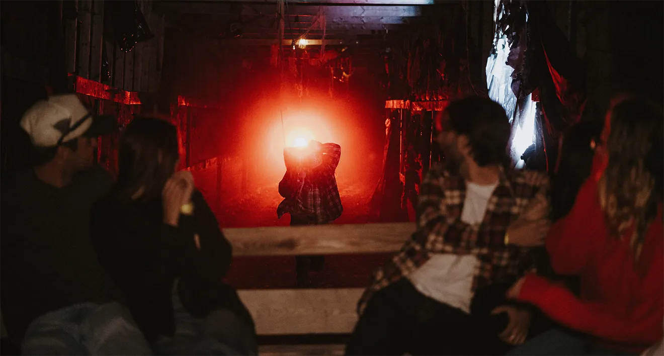 Point-of-view photograph of guests on the Saunders Farm night wagon ride with backlit actor.