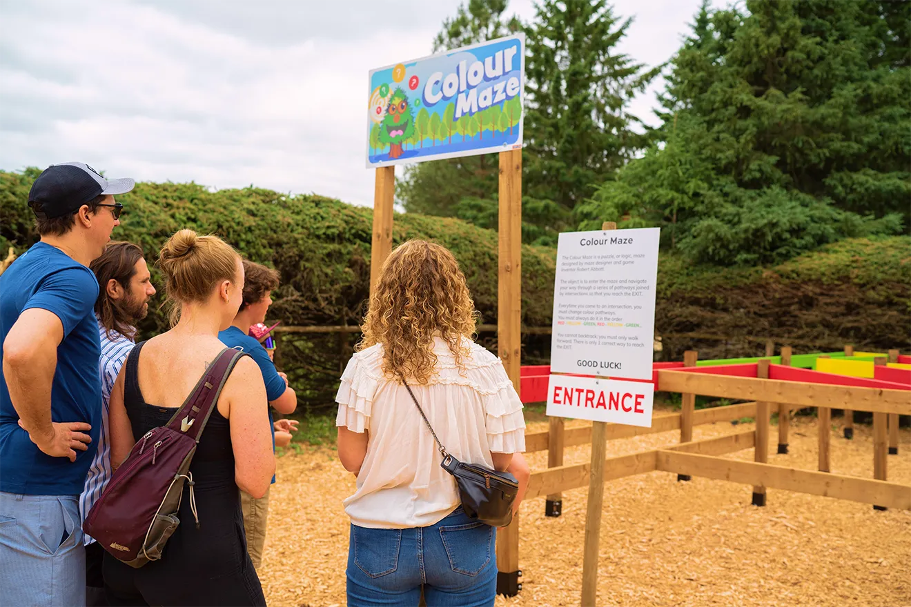Colour Maze entrance sign with vector character illustration and rules panel, designed by Hovski Studio.