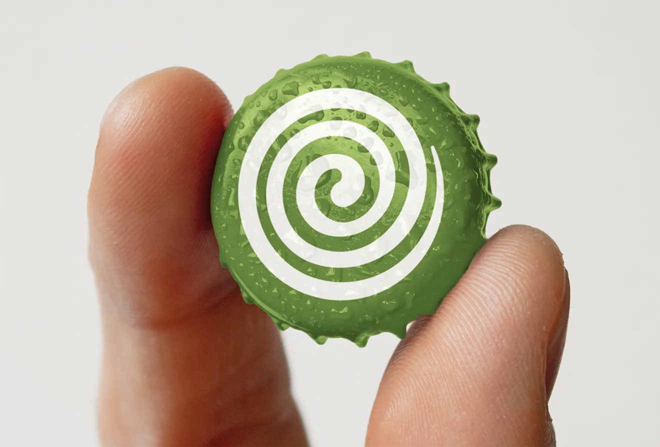 Close-up of wet green Saunders Cider bottle cap showing signature spiral brand asset, designed by Hovski Studio.