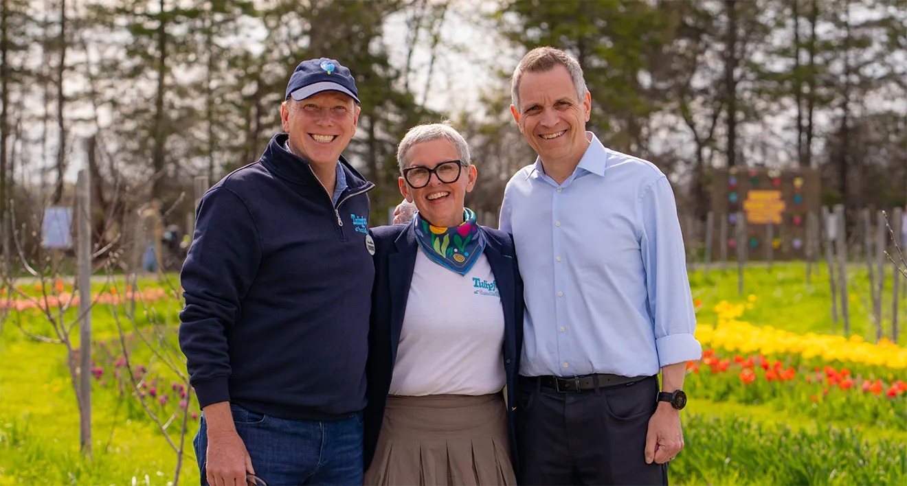 Mayor of Ottawa Mark Sutcliffe with Saunders Farm owners showcasing Hovski Studio Tulipfest merch.