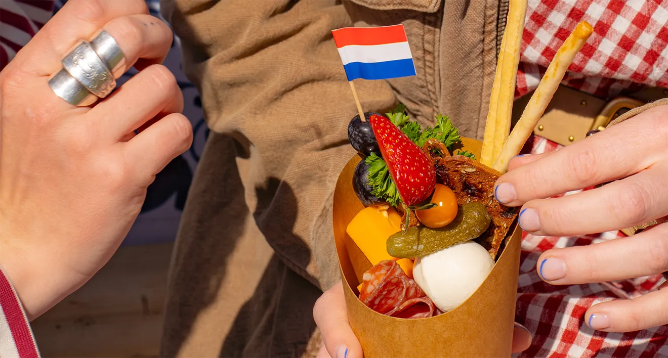 Dutch-inspired charcuterie snack cone with Netherlands paper flag for Tulipfest catering.