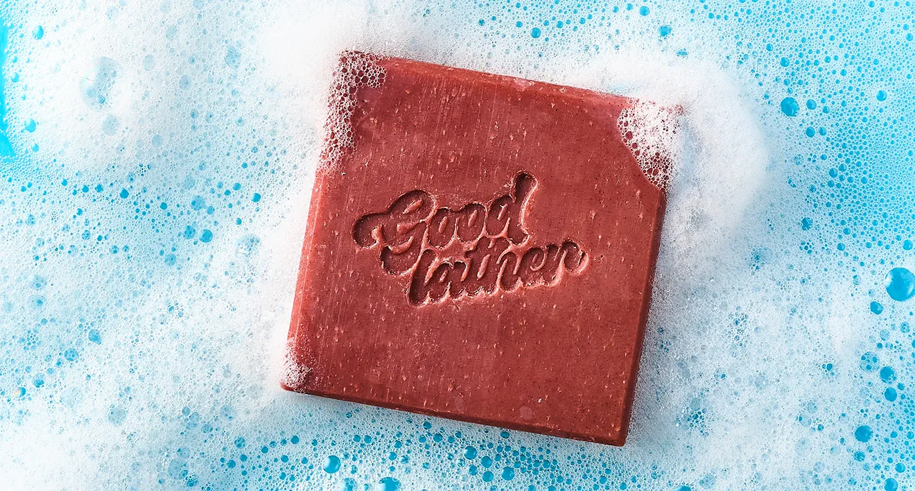 Goodlather Black Currant & Jasmine square soap bar in neon blue pool by Midnight Hour Studio.