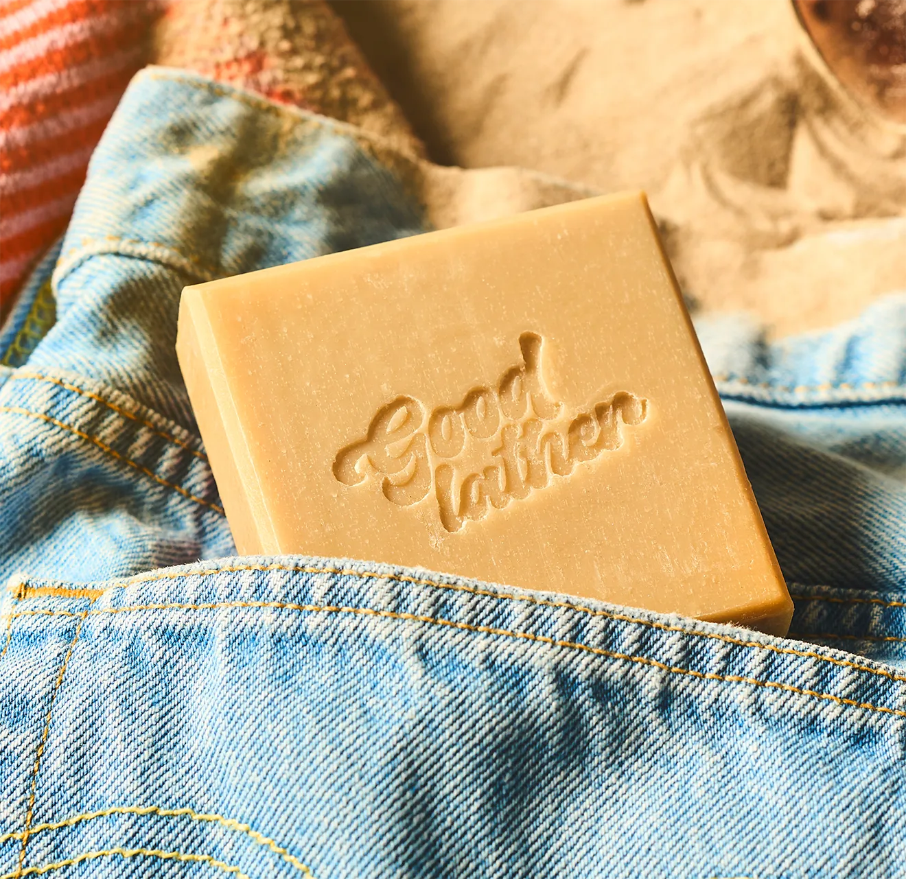 Goodlather Cedarmoss & Oak stamped bar soap in denim shorts pocket, shot by Midnight Hour Studio.