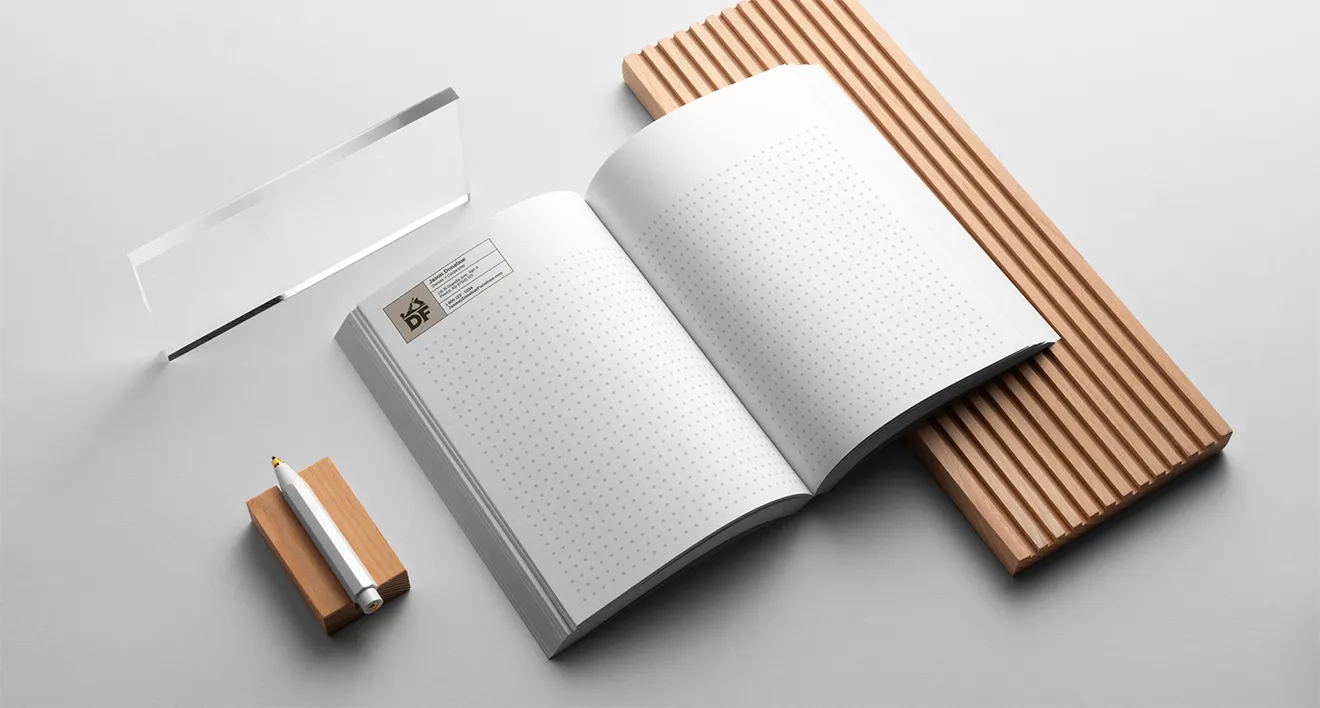 Dot-grid design journal with Donahue's Furniture custom carpentry logo by Hovski Studio.