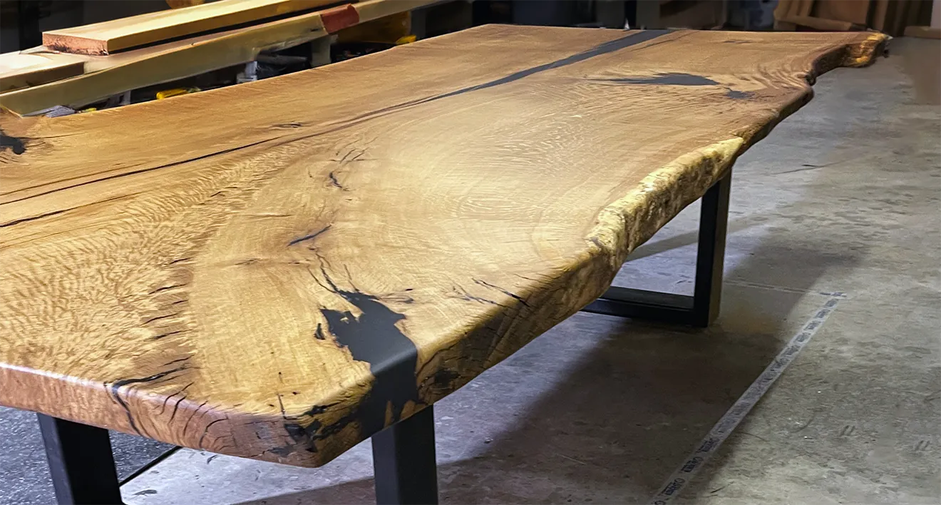 Live edge hardwood and black cement hybrid accent tables by Donahue Furniture.
