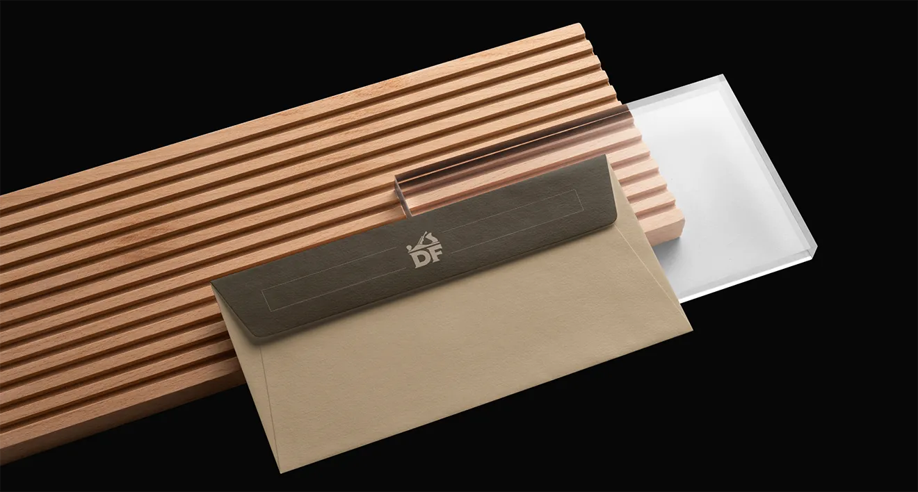 Custom envelope stationery design with logo for Donahue Furniture on hardwood timber.