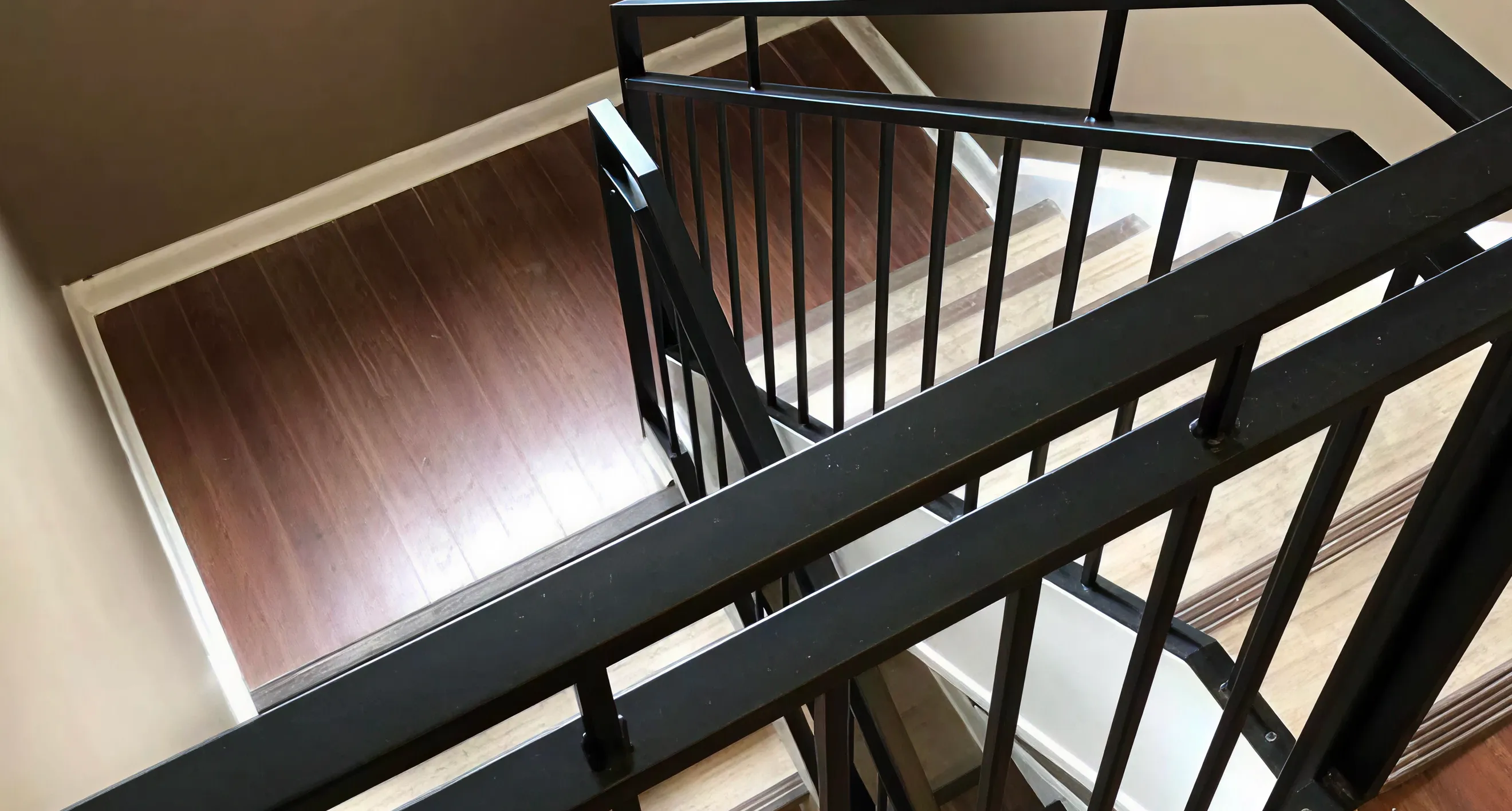 Custom black metal commercial staircase railing crafted by Lukas Grant Fabrication.
