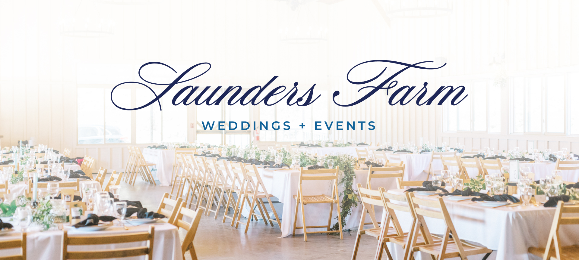 Interior view of The Pavilion wedding hall at Saunders Farm with the navy Saunders Farm Weddings logo by Hovski Studio.