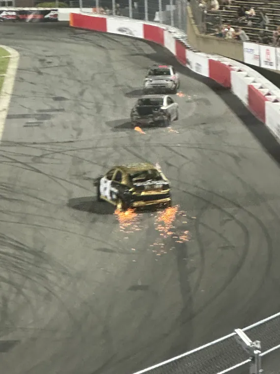Race cars sliding through a turn at Bowman Gray