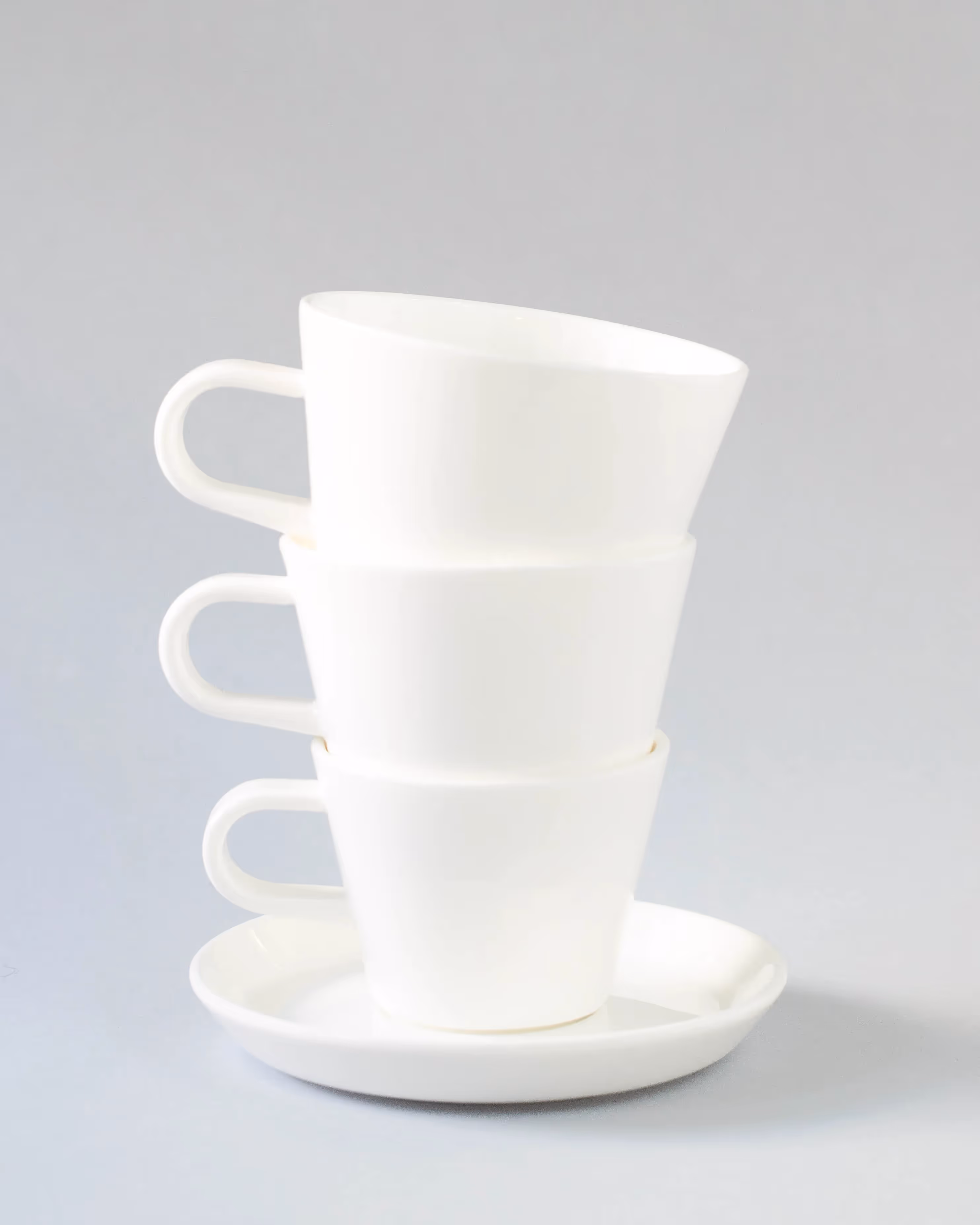 Stack of three white coffee cups