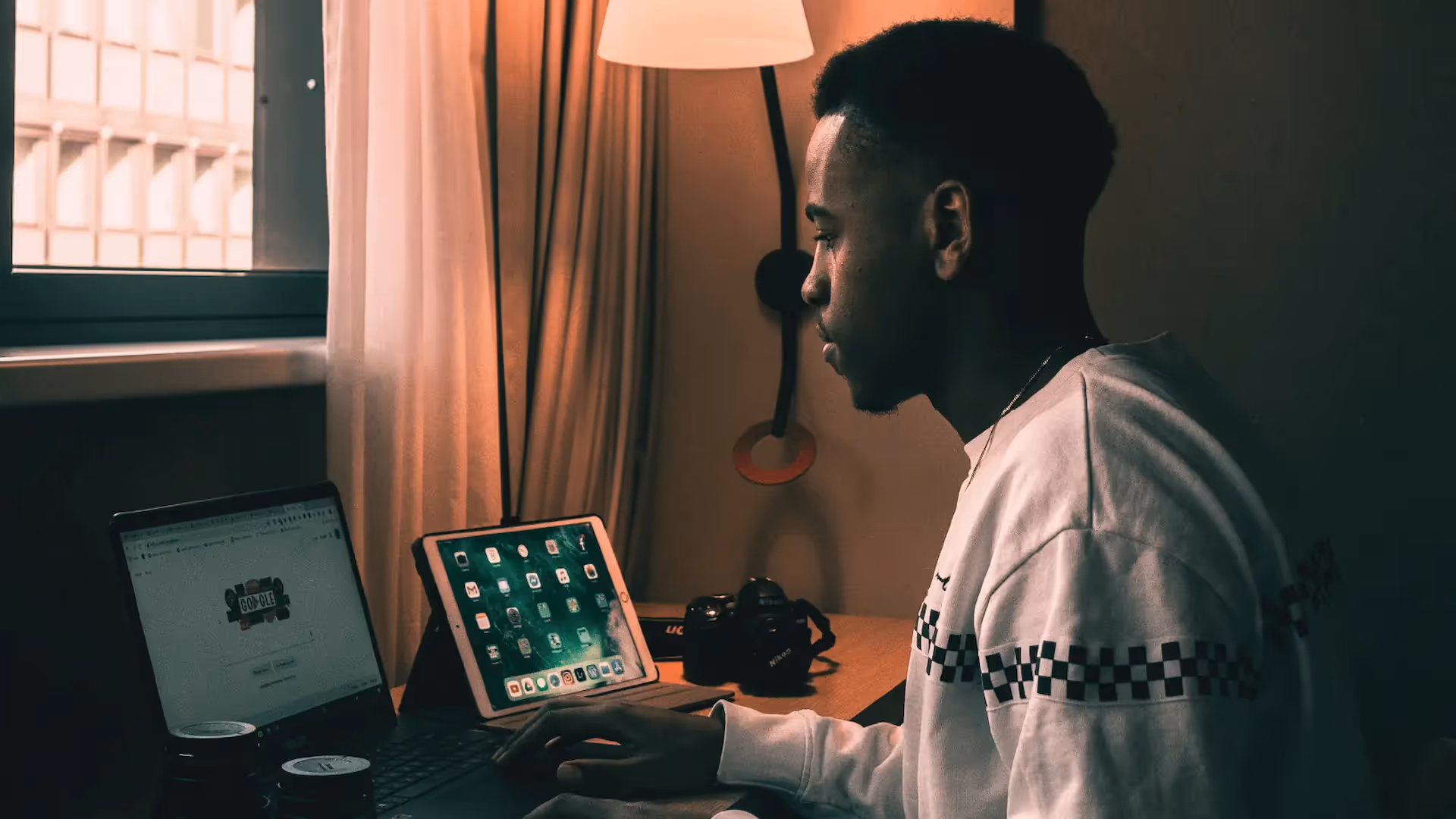 Man sitting in front of laptop and iPad