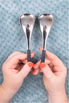 hands holding massage equipment