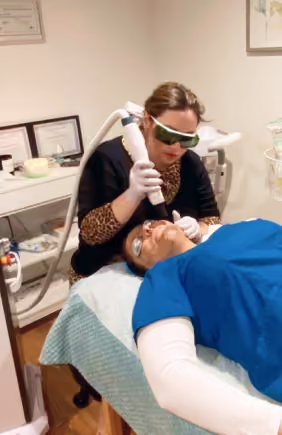 woman do facial hair removal procedure