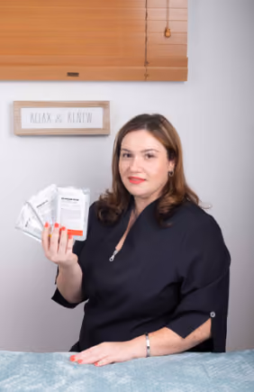 woman showing skin care products