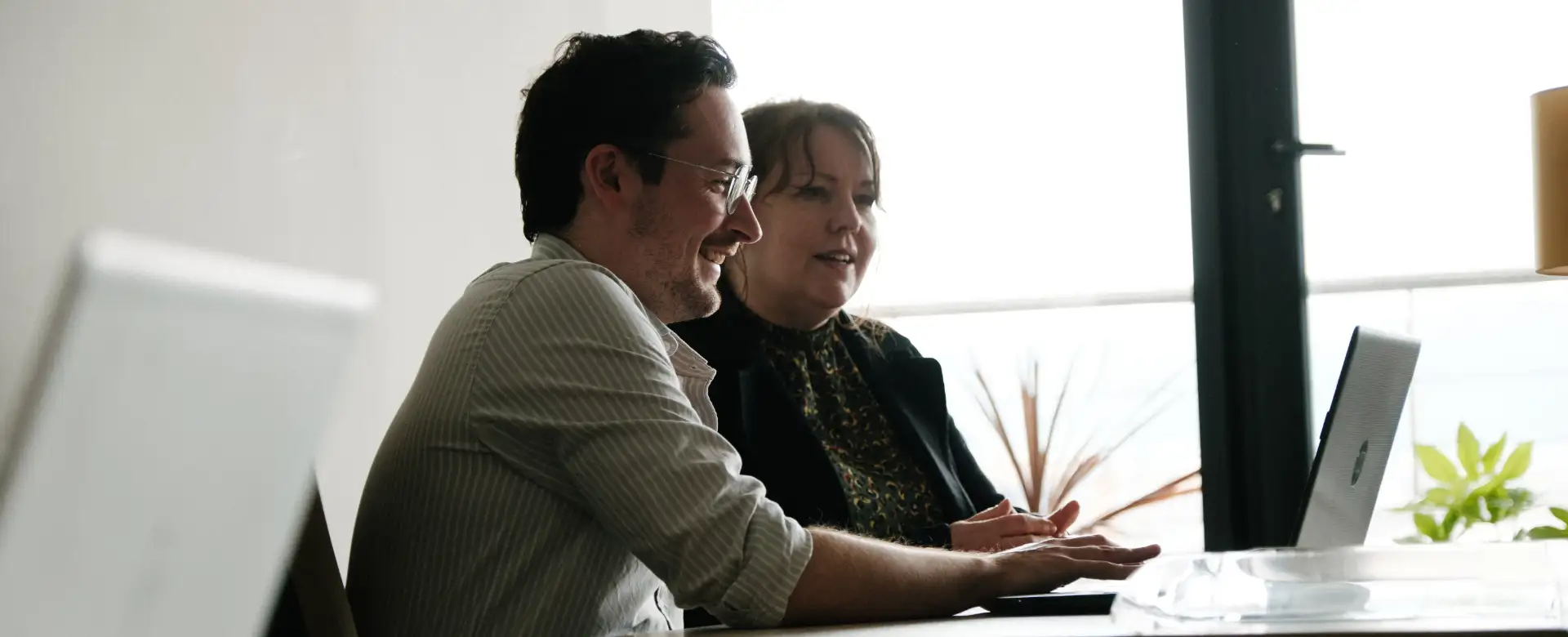 2 CES Team members worked together at a computer