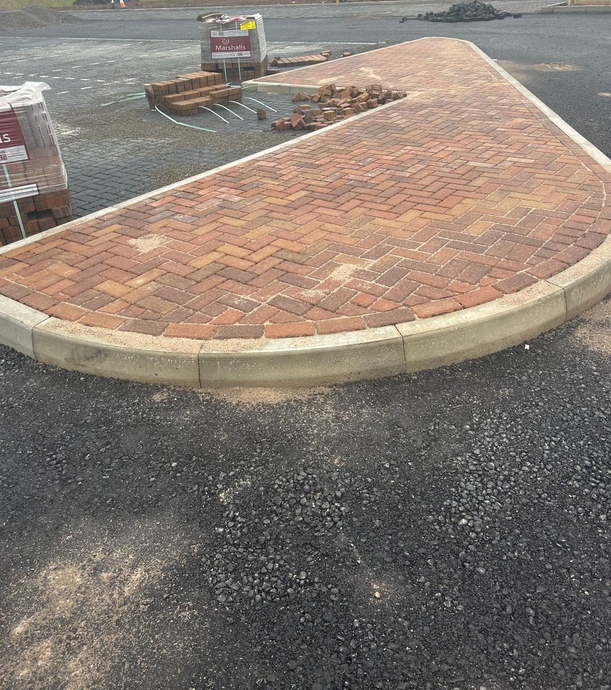 Groundworks service team installing paving and pathways