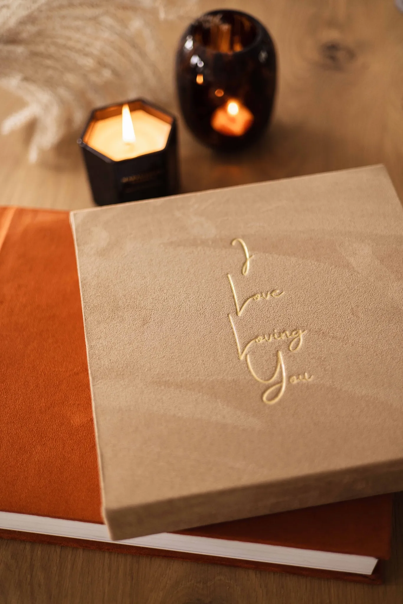 Het Grote Album - Nubuk (Zand) met een gouden embossing in een eigen ontwerp. Het album eronder is in de kleur Alpengloed.