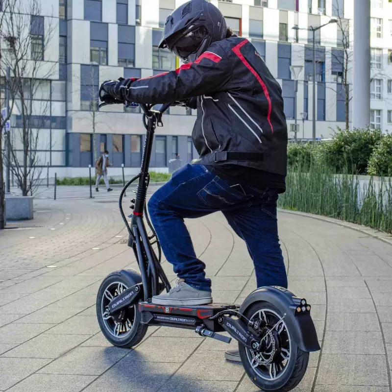 Un homme en train de monter sur une trottinette électrique Dualtron City.