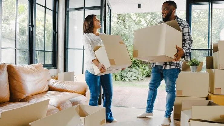 Un homme et une femme qui porte des cartons