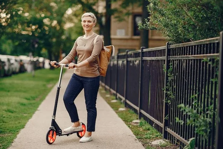 Une femme sur une trottinette électrique dans la rue