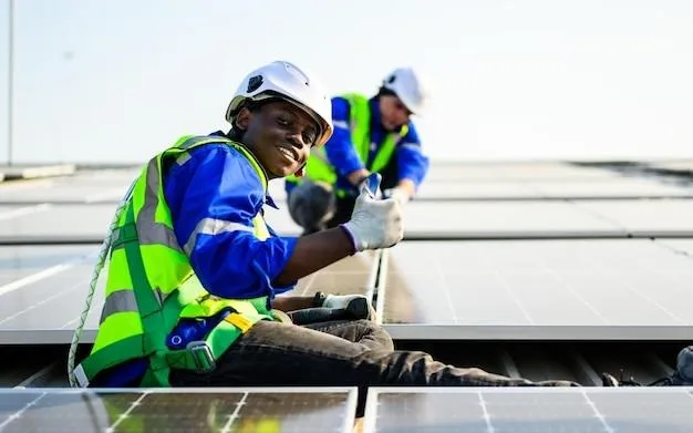 Deux artisans en gilet jaune qui installent des panneaux solaires