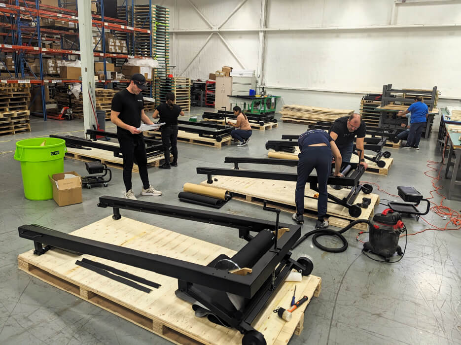 people assembling athletic device as part of contract manufacturing