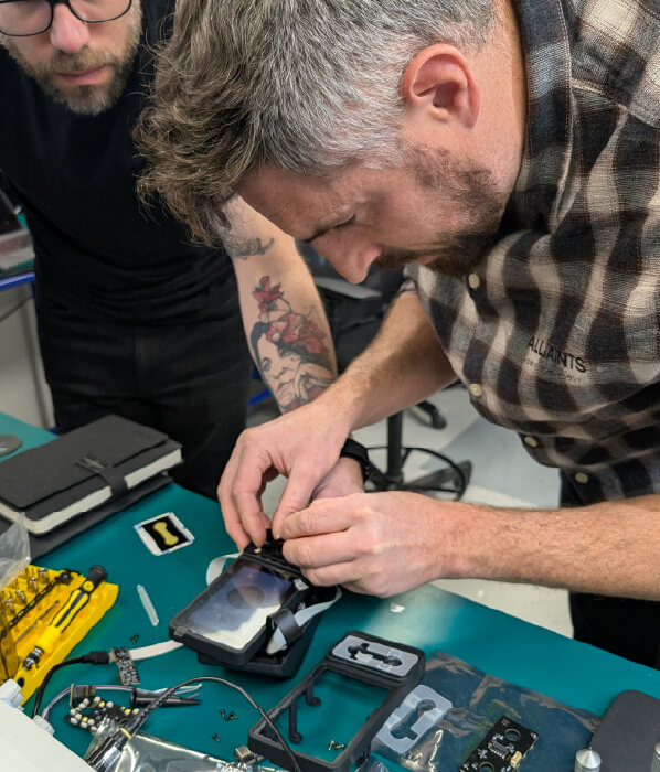 two people testing assembly of device for contract manufacturer