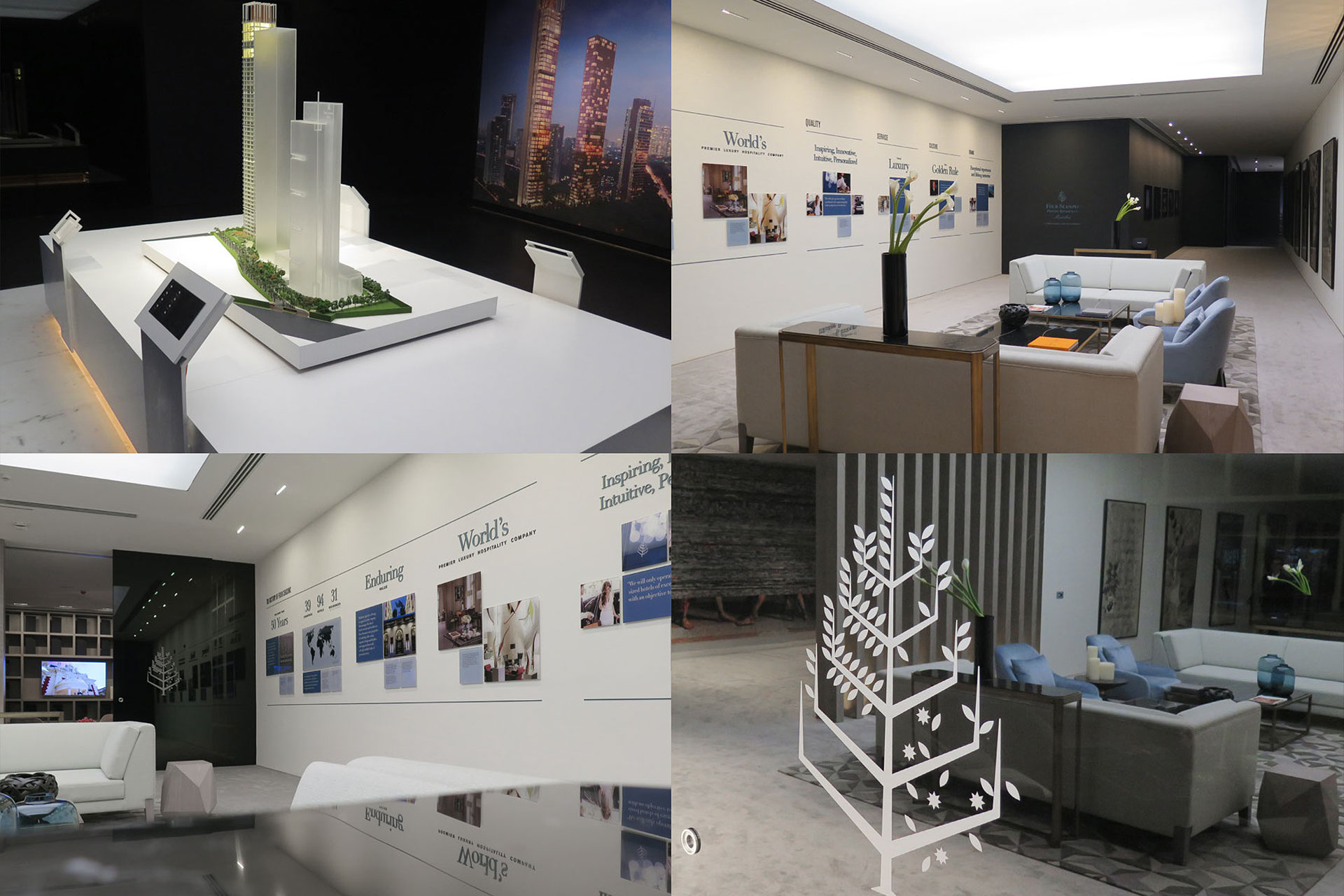 Modern showroom featuring a white architectural model of tall buildings on a table, and a stylish lounge area with sofas, armchairs, informational wall displays, and a decorative glass panel with a tree design.