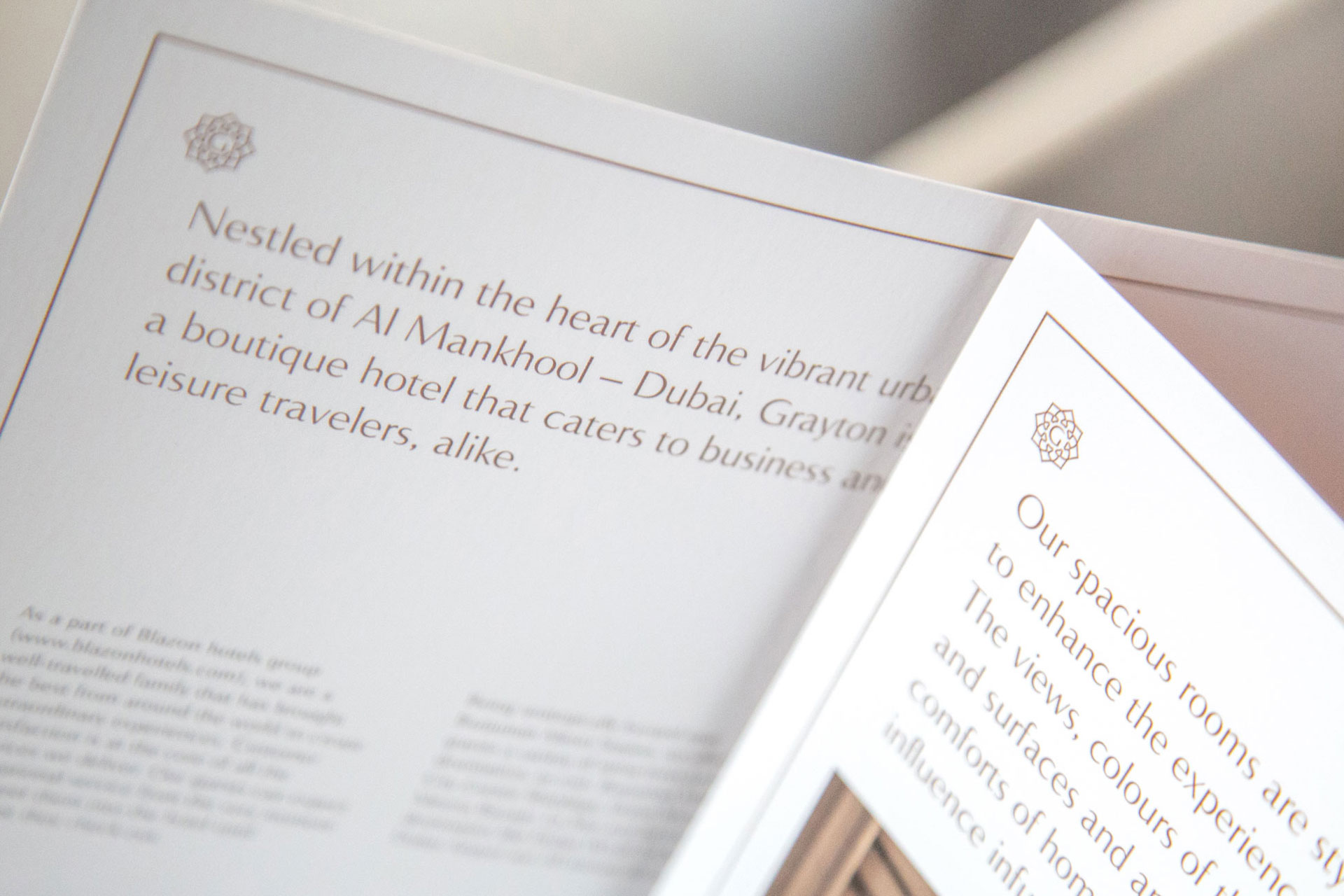 Close-up of a brochure page describing Grayton, a boutique hotel in Al Mankhool, Dubai, catering to business and leisure travelers.