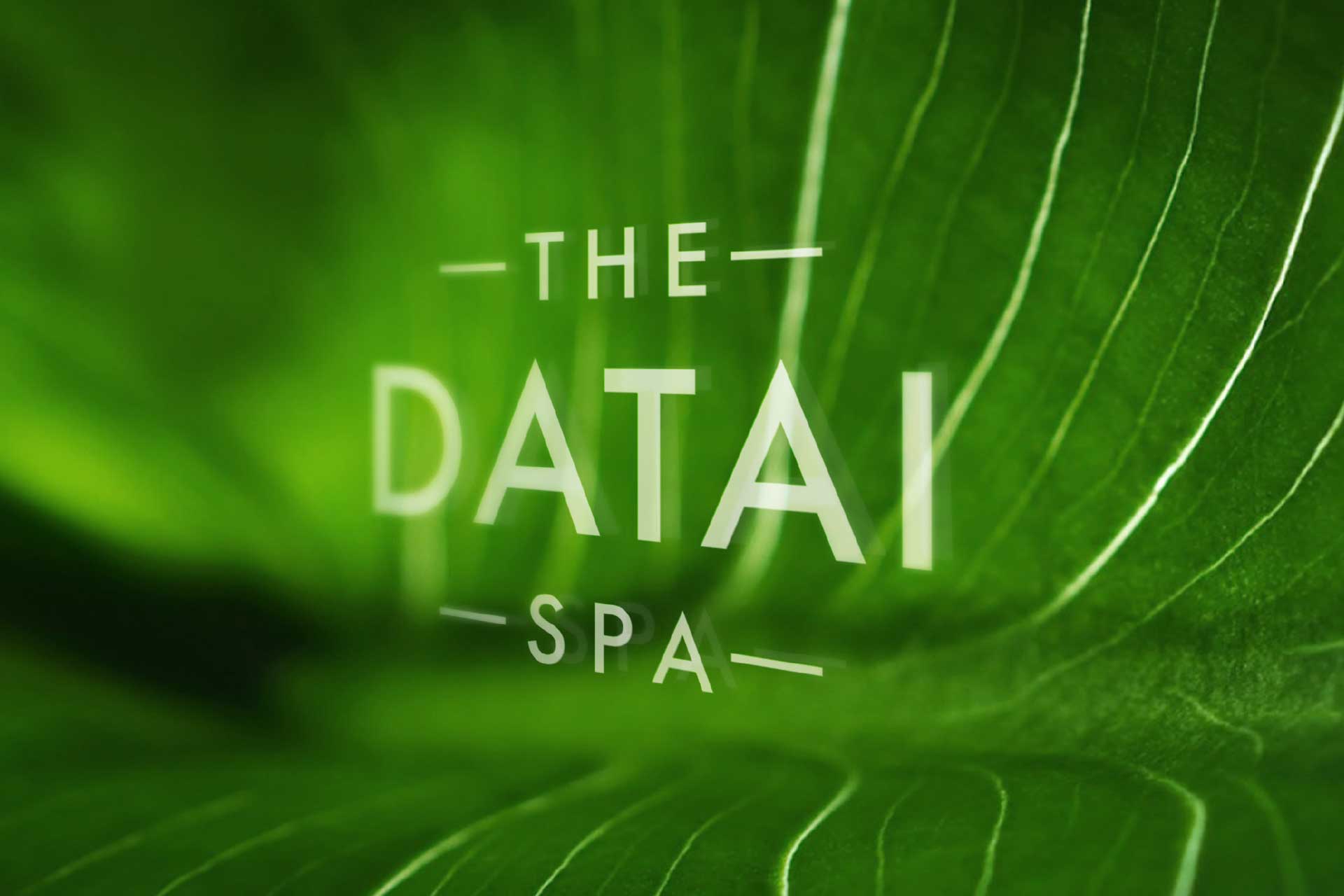 Close-up of a large green leaf with visible veins and the text 'The Datai Spa' overlaid.
