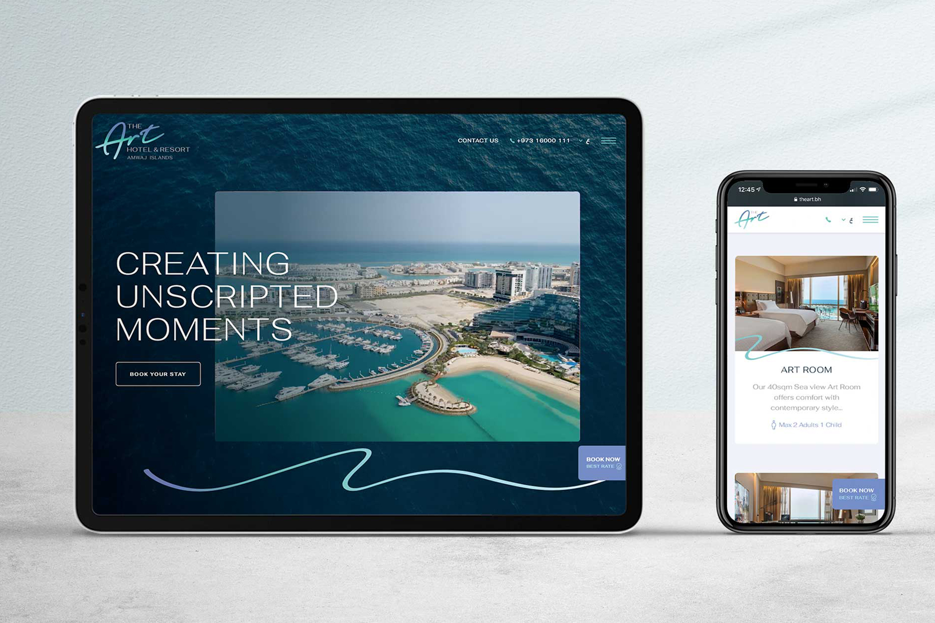Tablet and smartphone displaying The Art Hotel & Resort website with aerial view of marina and sea, and a hotel room interior.