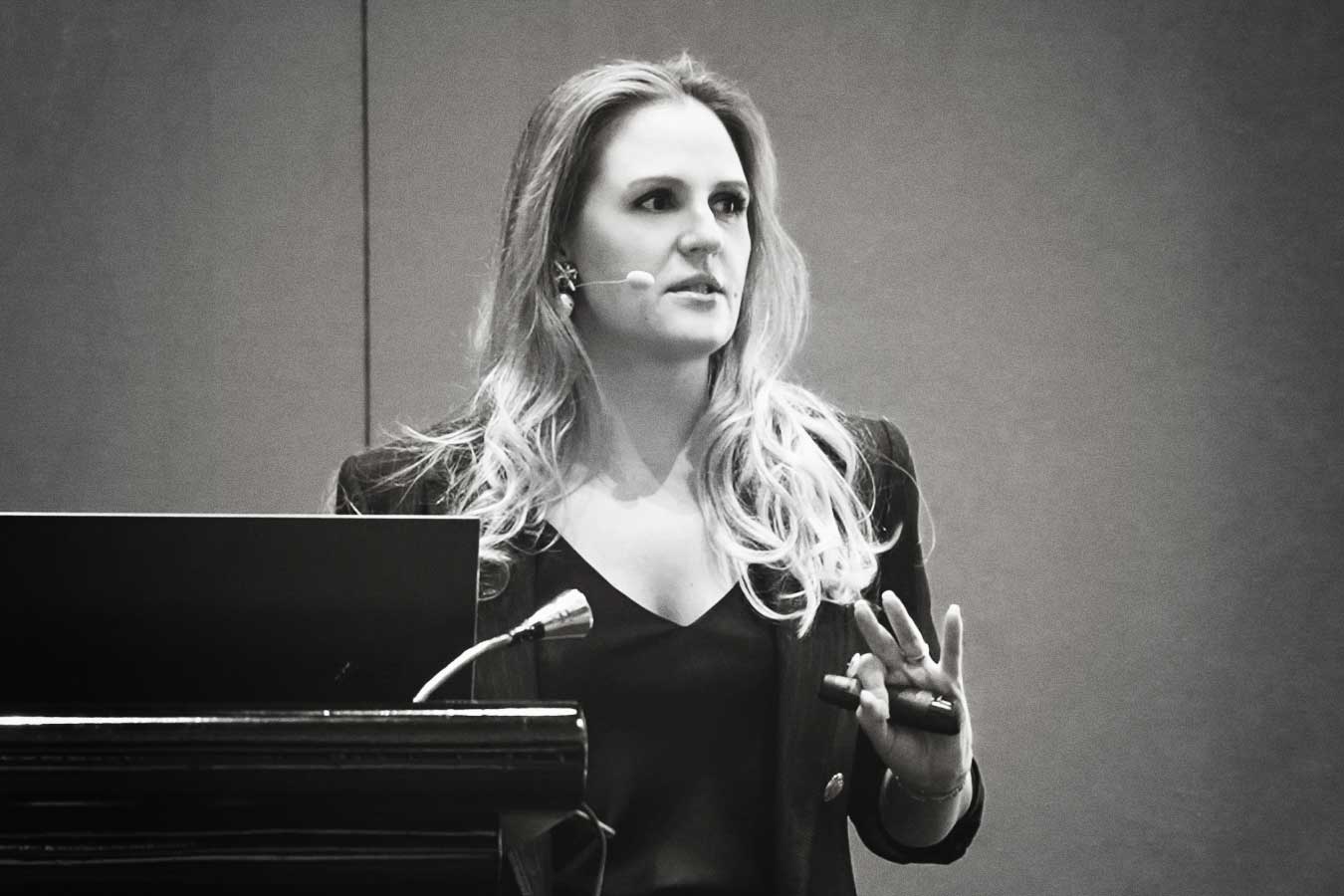 Photographic image of Nina Seredai, partner at Brandteliers and head of strategy at the agency, speaking at an hospitality industry event.