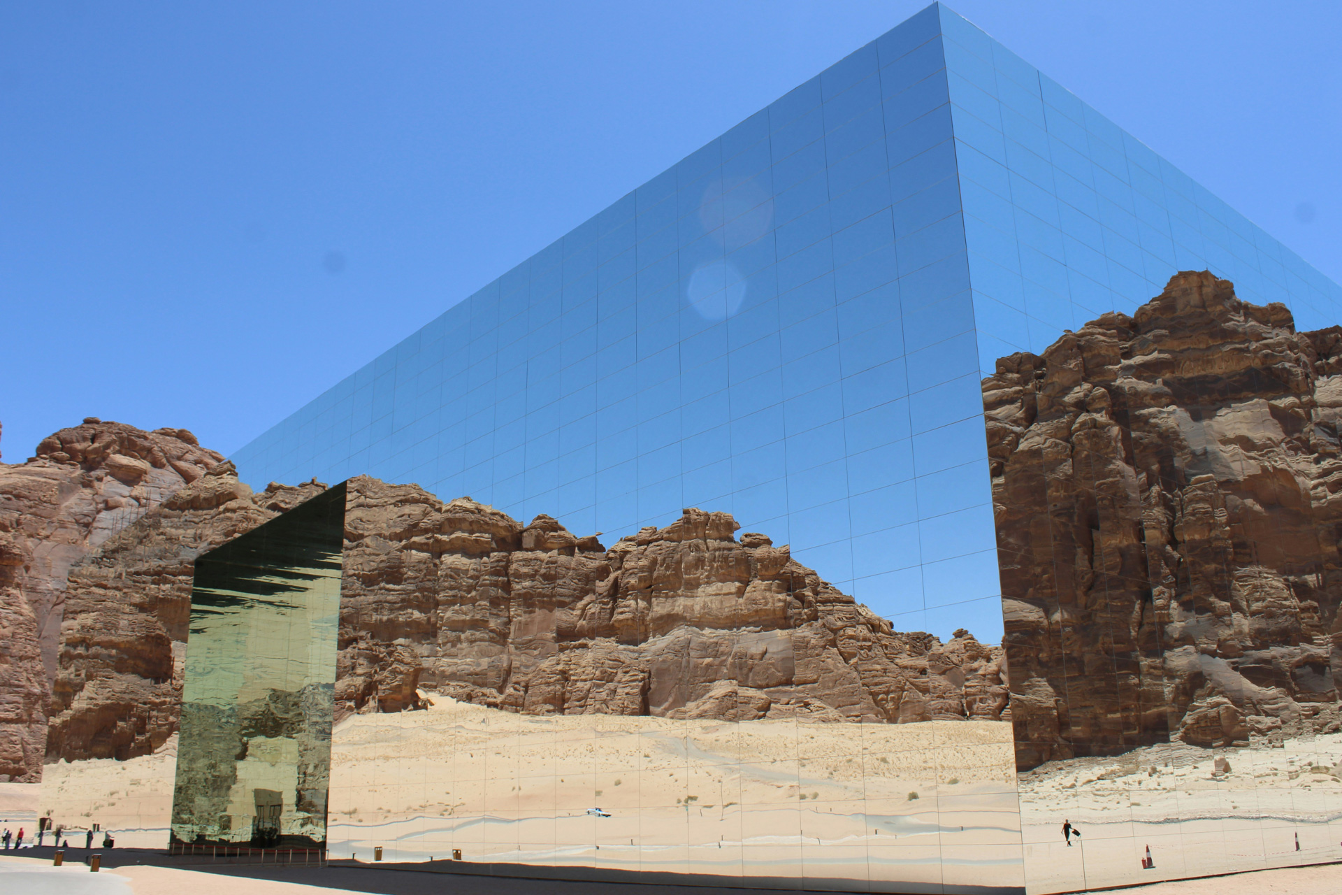 Hotel staff member in traditional uniform holding a garment bag labeled 'Giza Palace Hotel & Spa'.
