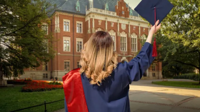 Graduate in a blue academic gown and red sash in front of Jagiellonian University, in Krakow, Poland