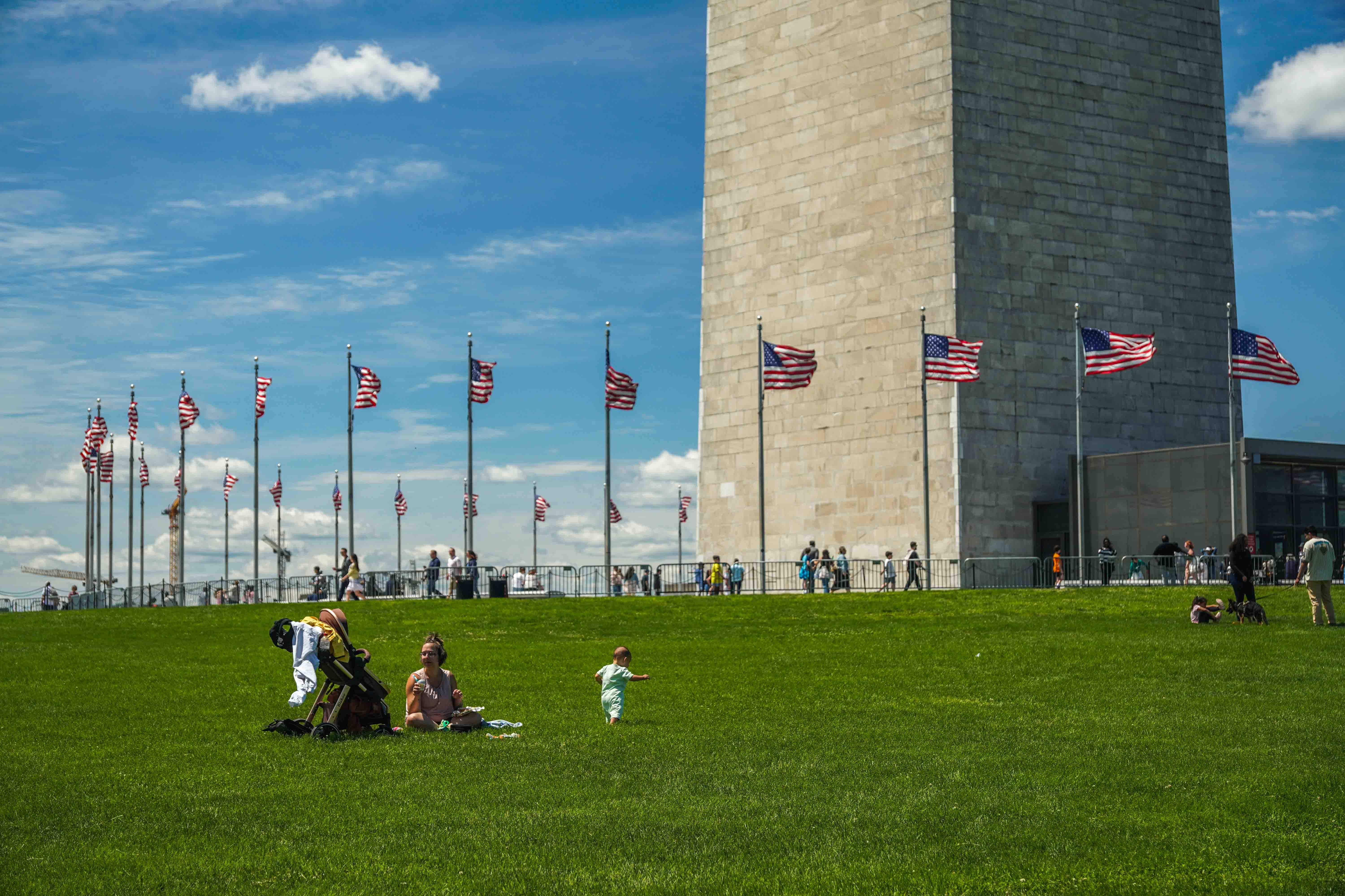 A mom looks after her children under the Washington Monument