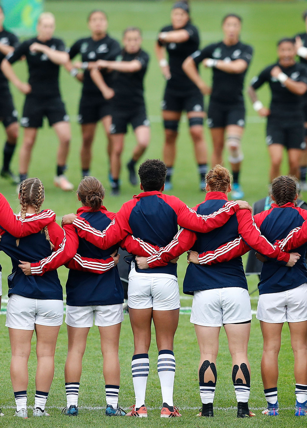 Innovative Thought high performing teams home image. USA womens rugby team facing New Zealand rugby team haka before a test match.