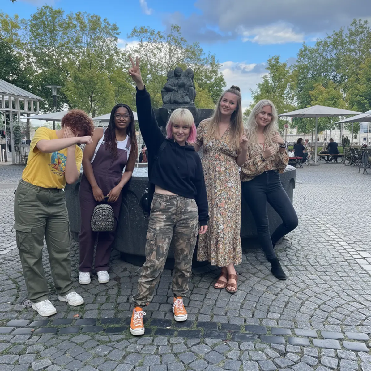 Group laughing together during their team event in Cologne
