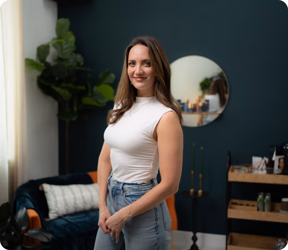 A woman standing in a room with green walls.