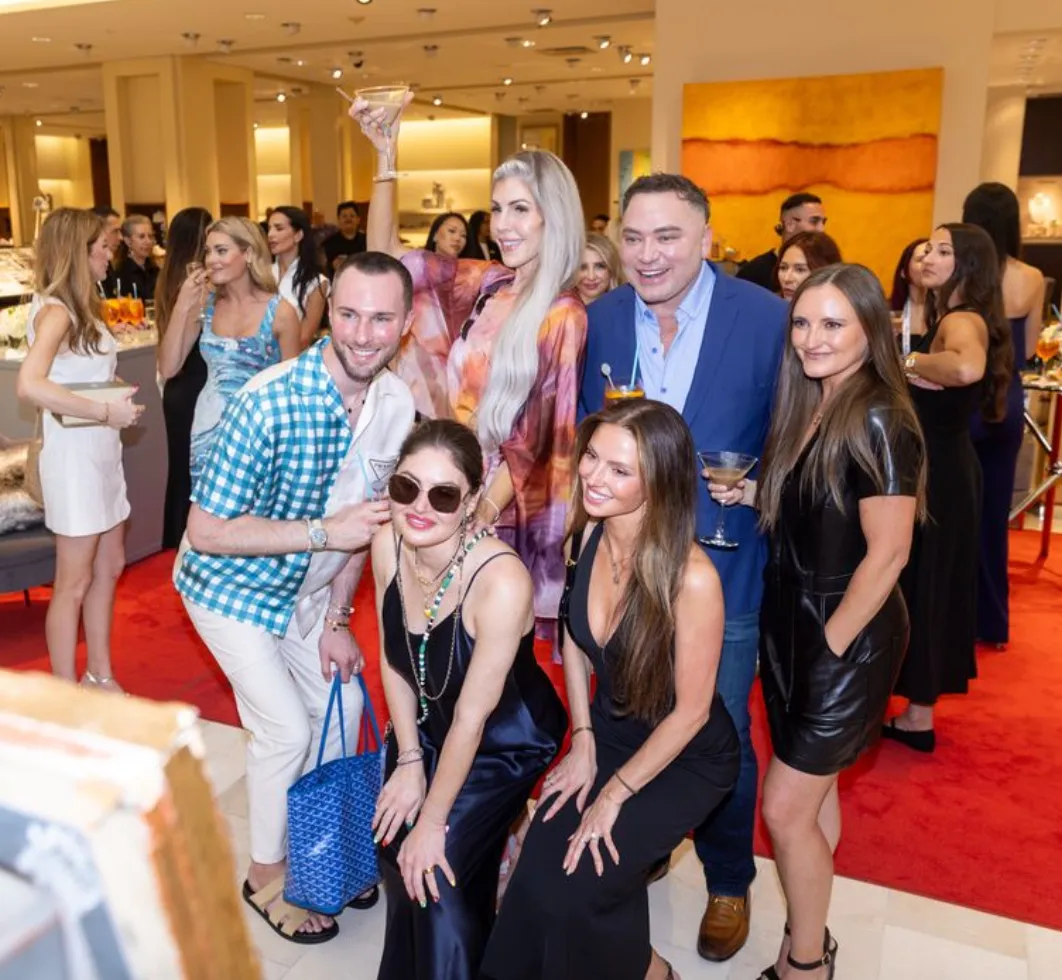 A woman wearing sunglasses looking at her cell phone.