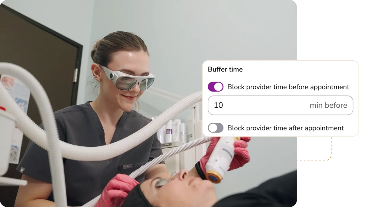 Woman wearing safety glasses and pink gloves using a handheld device for a facial treatment on a person lying down, with a screen overlay showing buffer time settings for appointments.