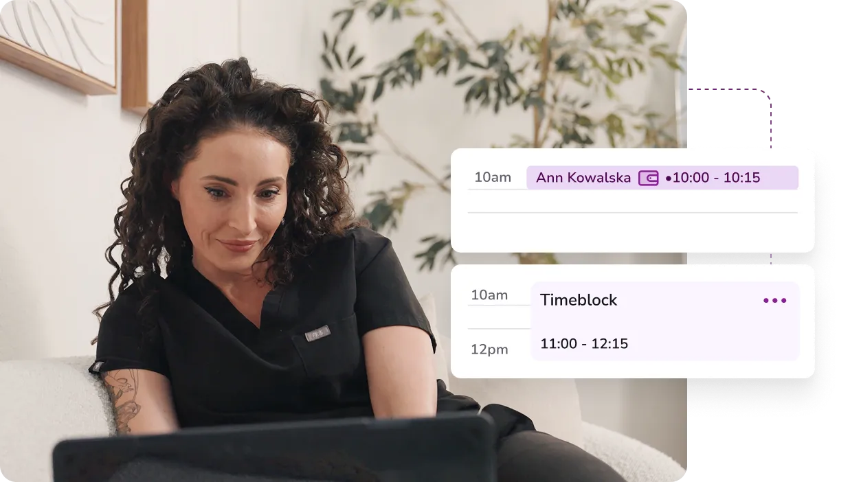 Woman with curly hair wearing black scrubs sitting on a couch and looking at a laptop, with digital schedule overlays showing appointments.