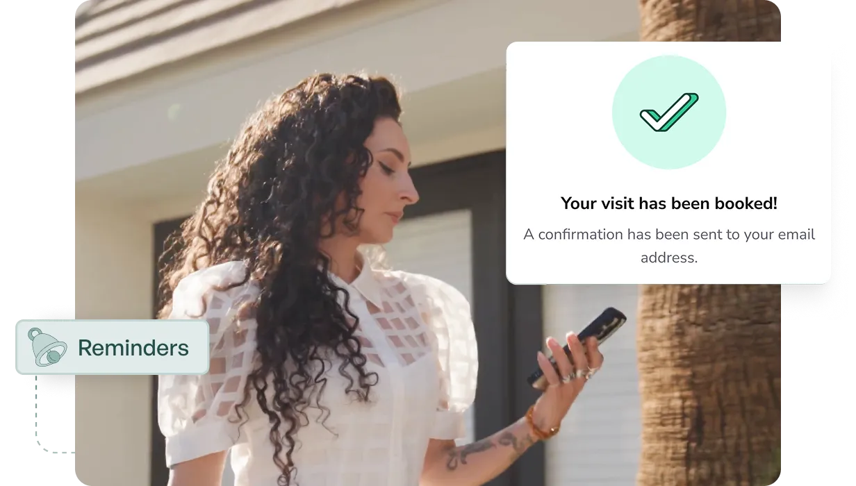 Woman with long curly hair wearing a white patterned blouse looks at her phone outdoors near a tree, with overlay notifications for Reminders and visit booking confirmation.