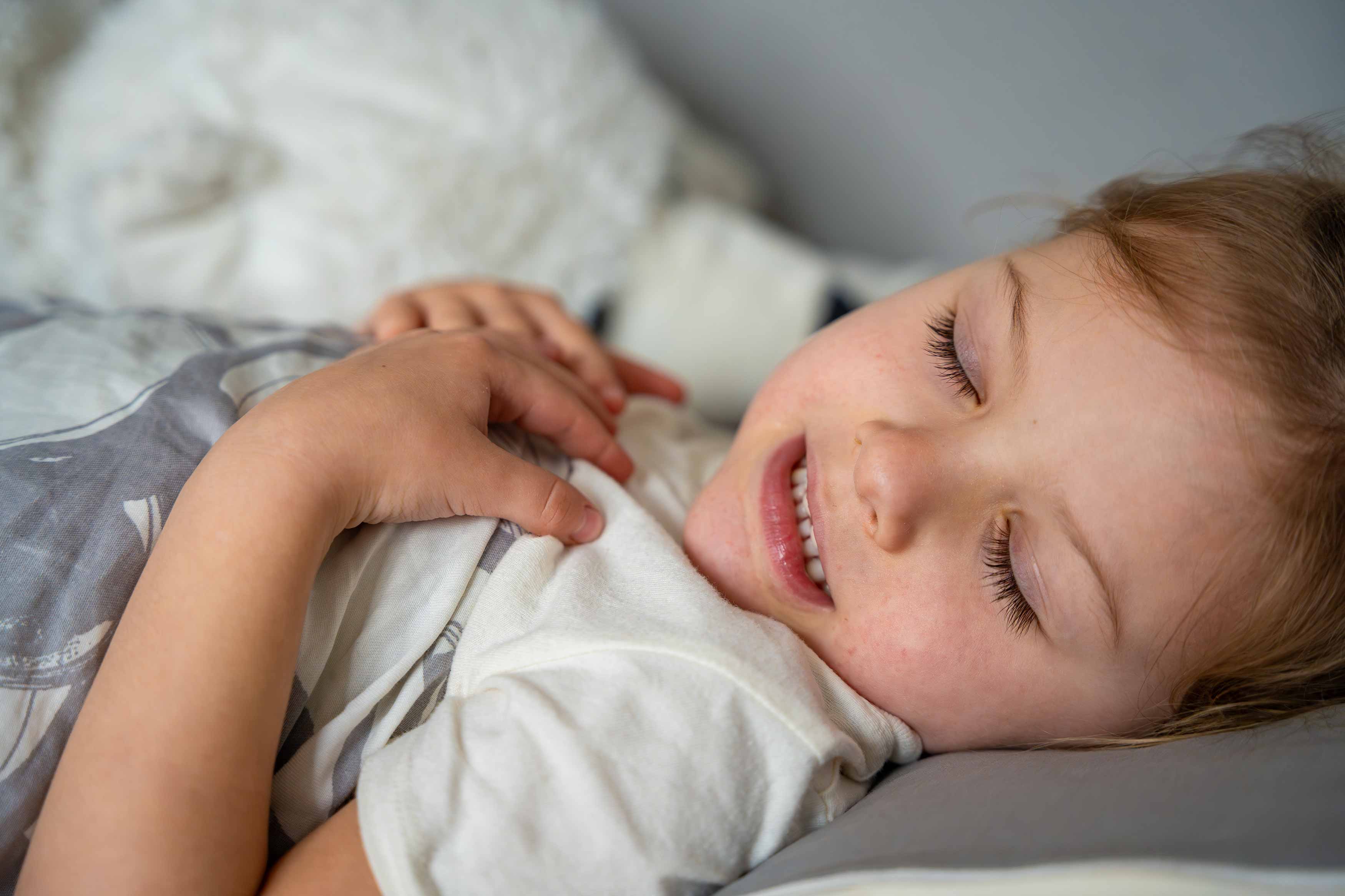 young girl sleeping in bed grinding her teeth 