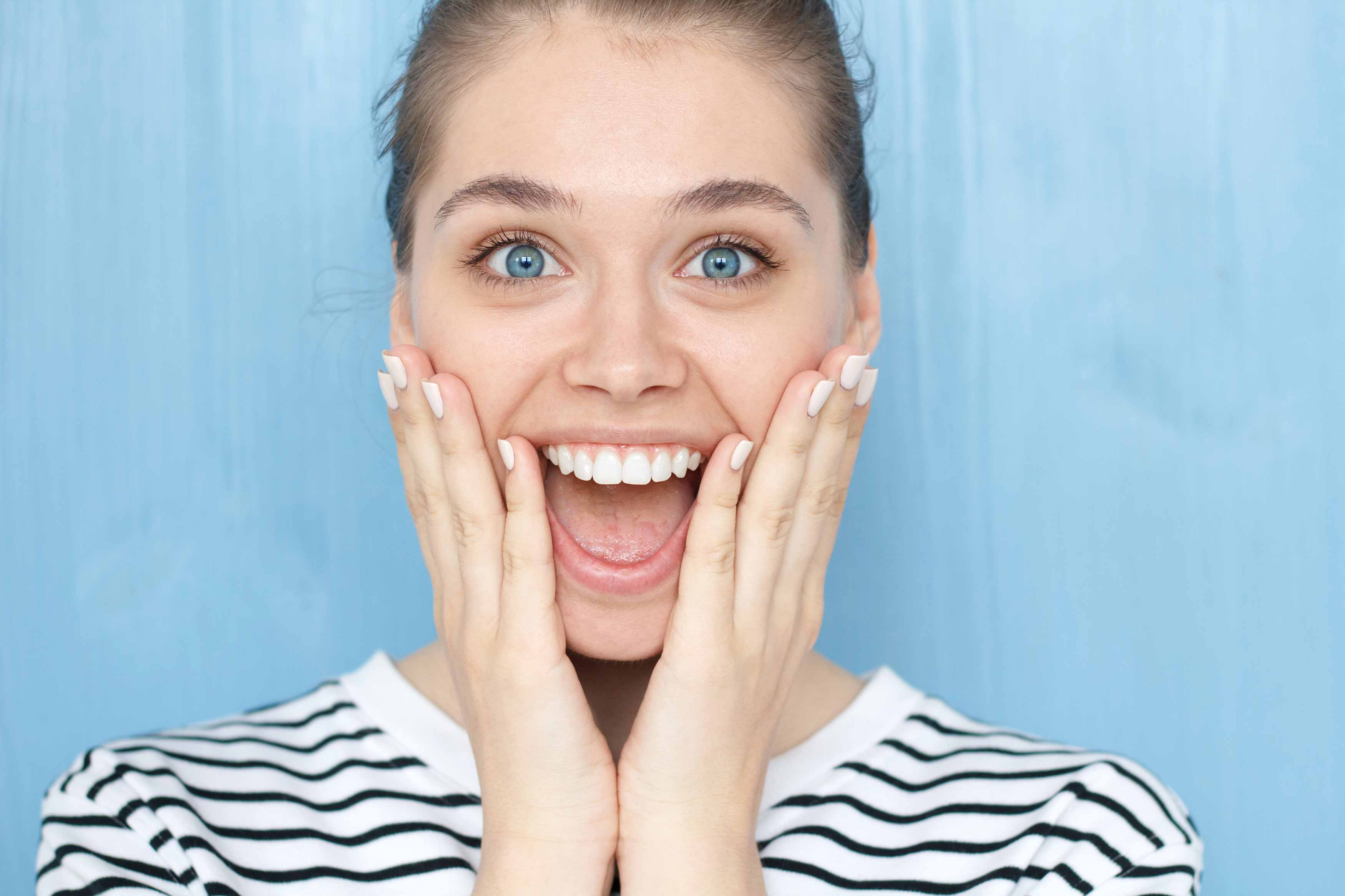 A photo of female smiling brightly showing off her upper teeth